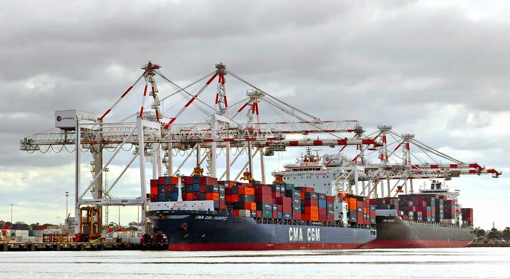 Container terminal with stacked shipping containers at a working port
